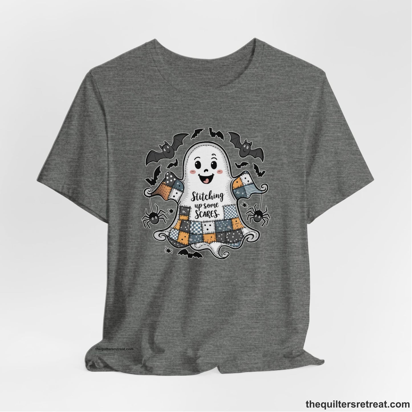 A Deep Heather Short Sleeve T-Shirt with a cute patchwork ghost with "Stitching up some Scares" text and playful bats in a whimsical style