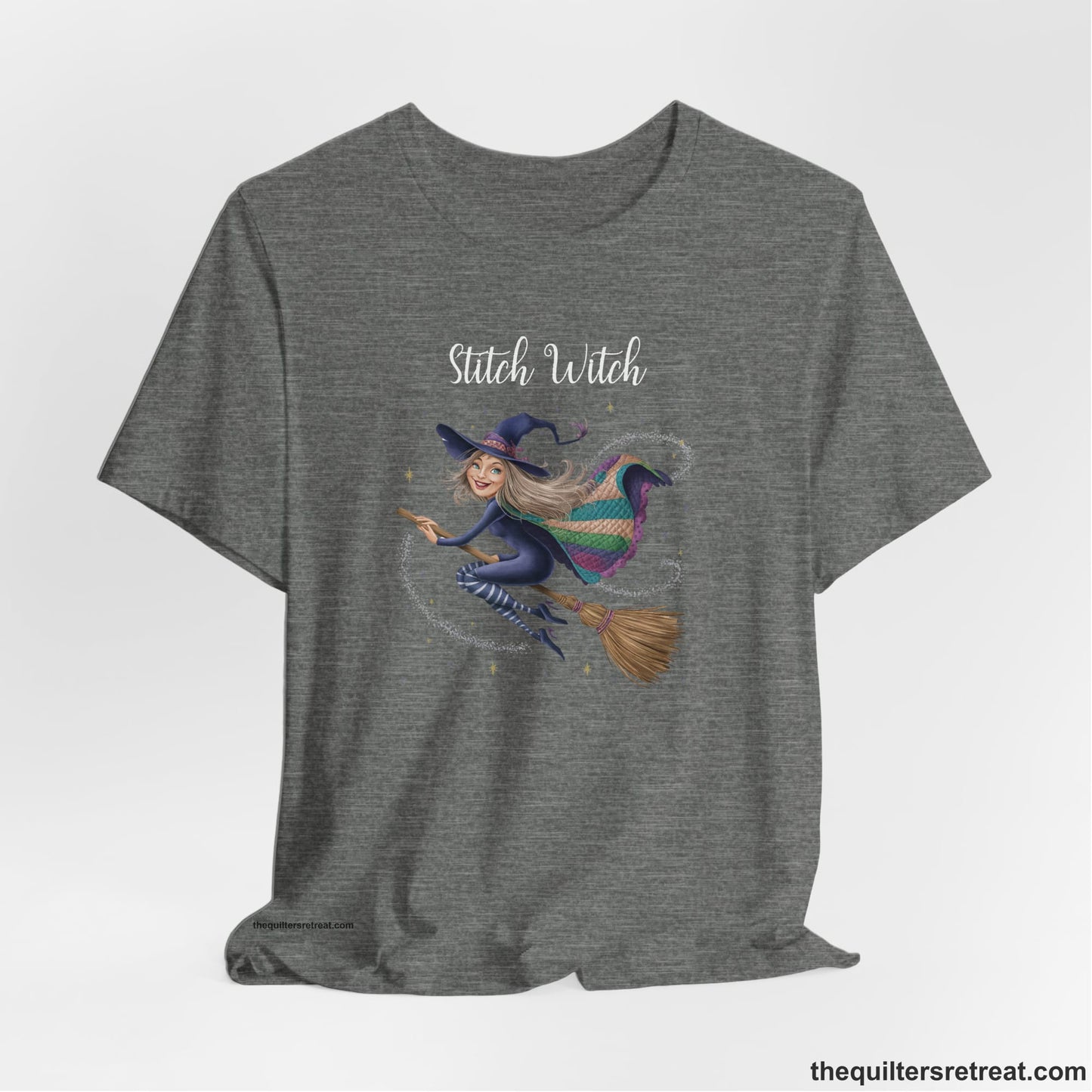 A Deep Heather Short Sleeve T-Shirt with a playful witch on broomstick with patchwork cape and starry background in a whimsical style