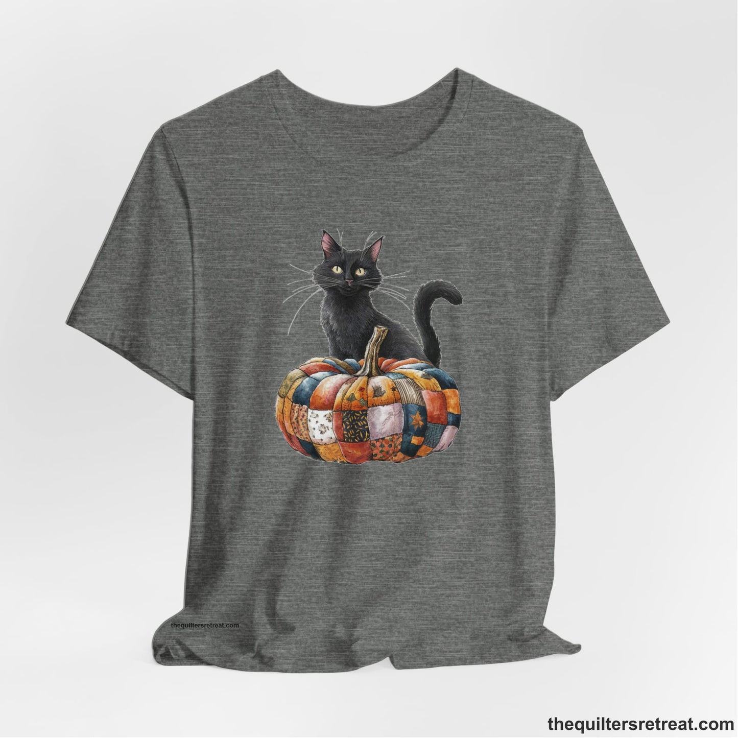 A Deep Heather Short Sleeve T-Shirt with a black cat with a quilted patchwork pumpkin in a whimsical autumn style