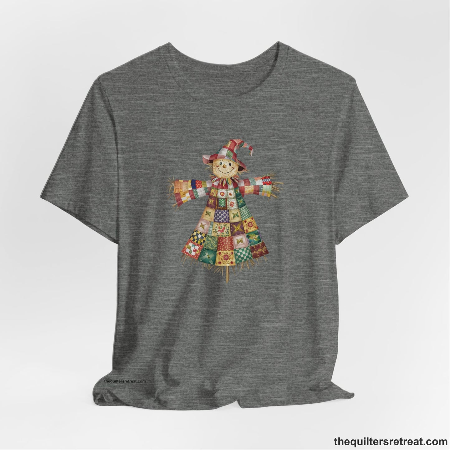 A Deep Heather Short Sleeve T-Shirt with a patchwork scarecrow with a cheerful face in a whimsical style