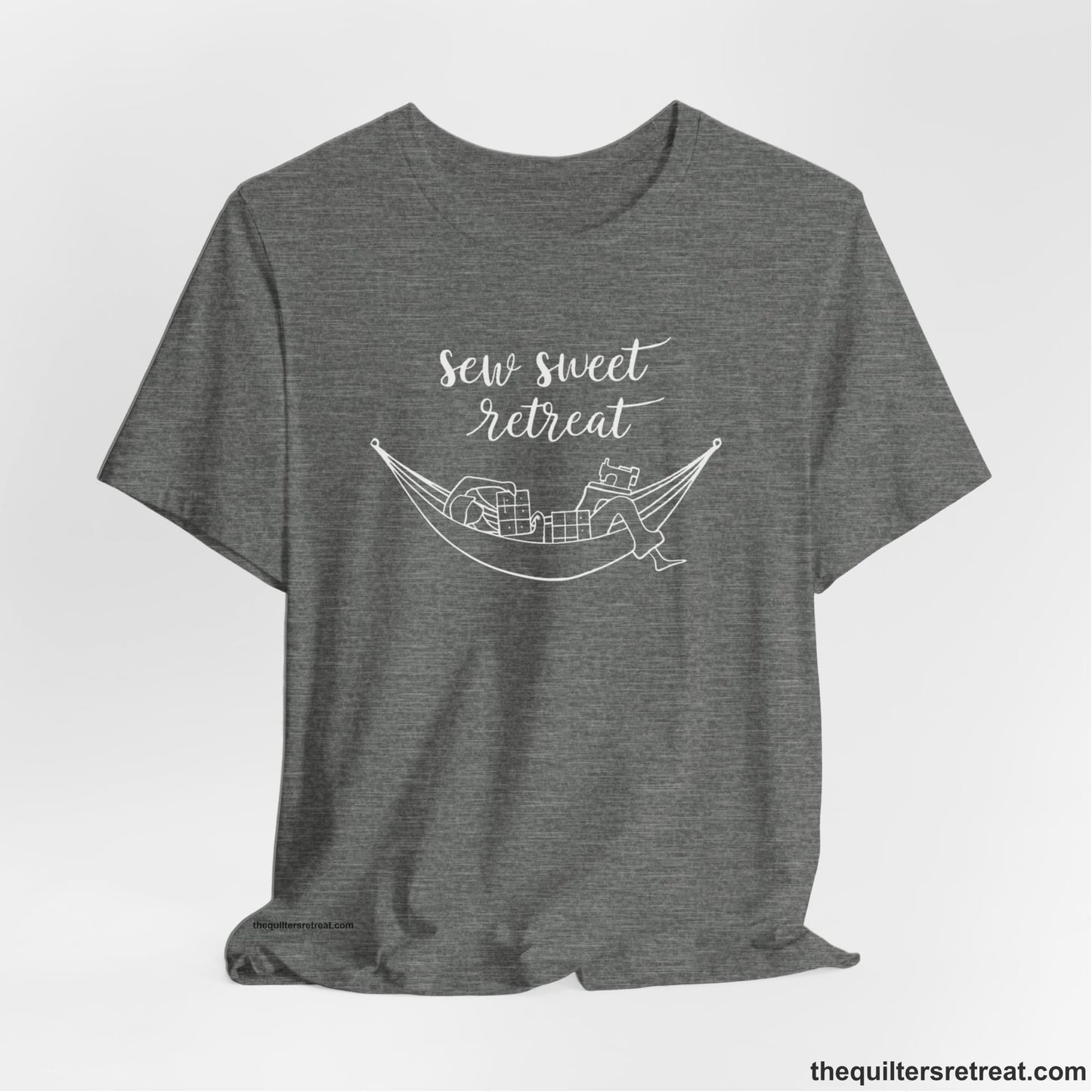 A Deep Heather Short Sleeve T-Shirt with a sewing machine and thread spools with "Sew Sweet Retreat" in whimsical script