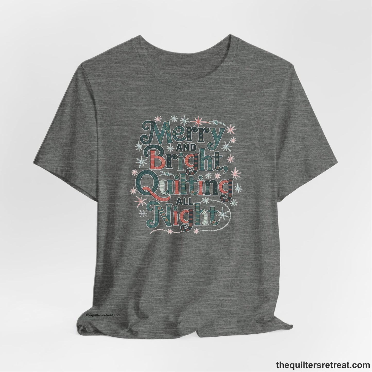 A Deep Heather Short Sleeve T-Shirt with a Merry and Bright Quilting All Night text with festive patterns and stars in a whimsical style