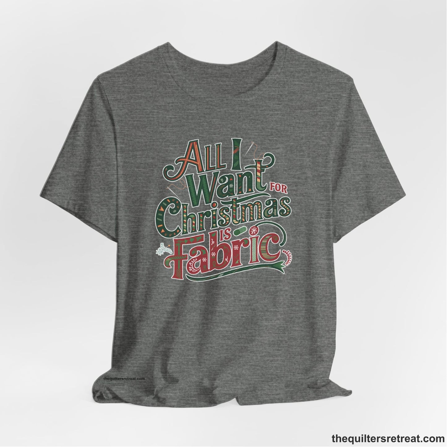 A Deep Heather Short Sleeve T-Shirt with a vintage holiday text "All I Want for Christmas is Fabric" with festive motifs