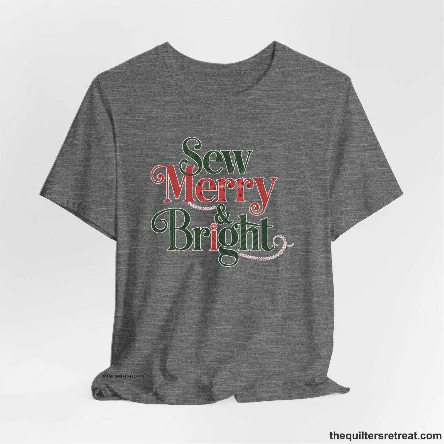 A Deep Heather Short Sleeve T-Shirt with a festive "Sew Merry & Bright" text with decorative holiday patterns