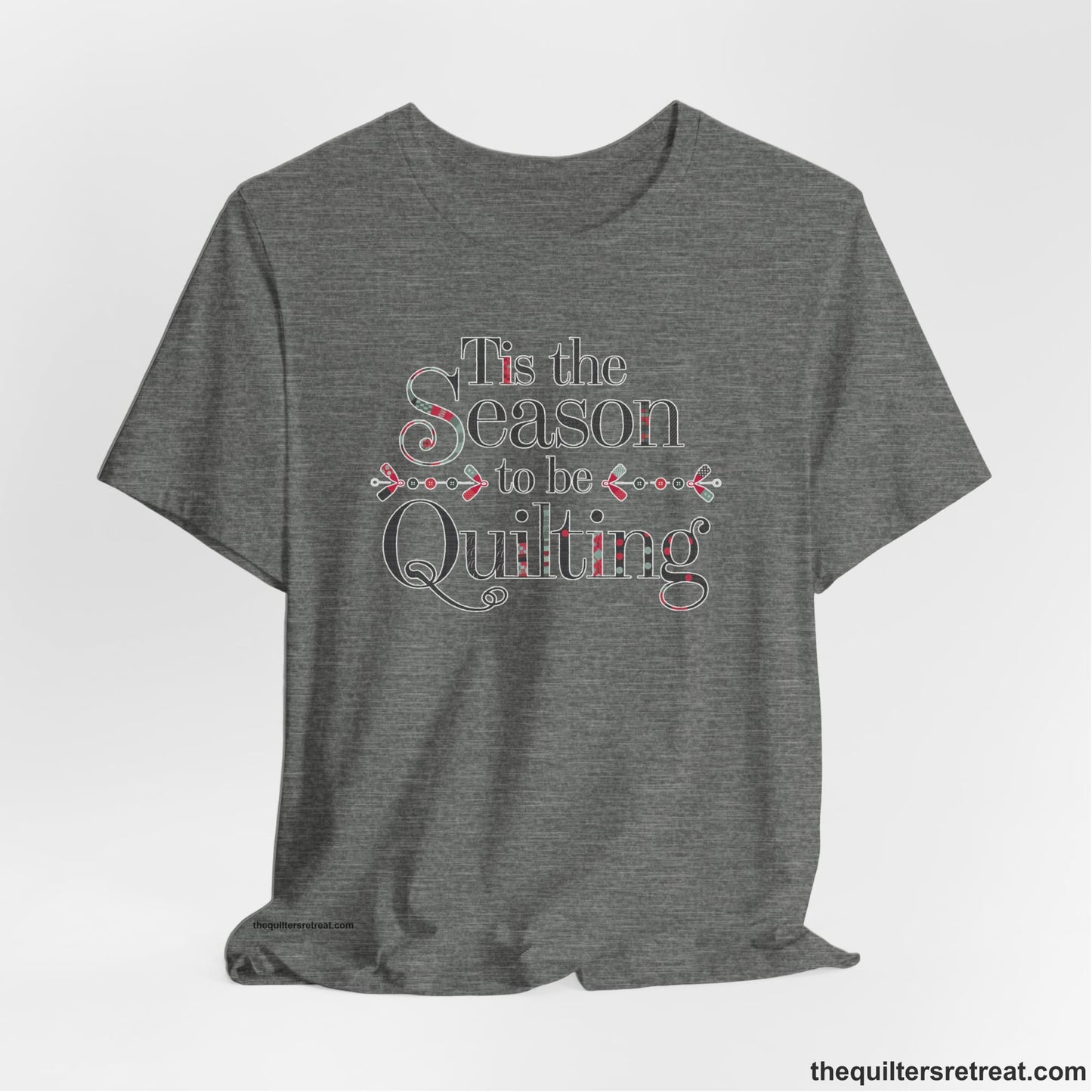 A Deep Heather Short Sleeve T-Shirt with a tis the season to be quilting text with festive patchwork pattern in a cheerful style