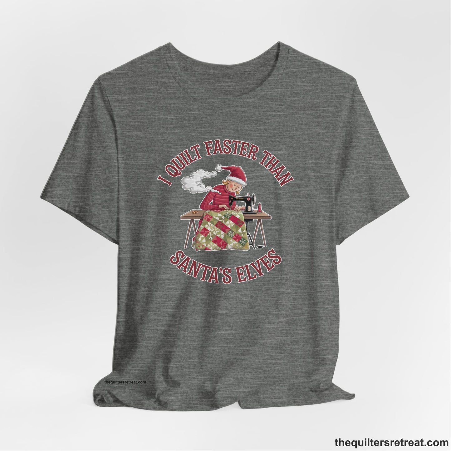 A Deep Heather Short Sleeve T-Shirt with a whimsical illustration of a quilting woman with "I Quilt Faster Than Santa's Elves" text