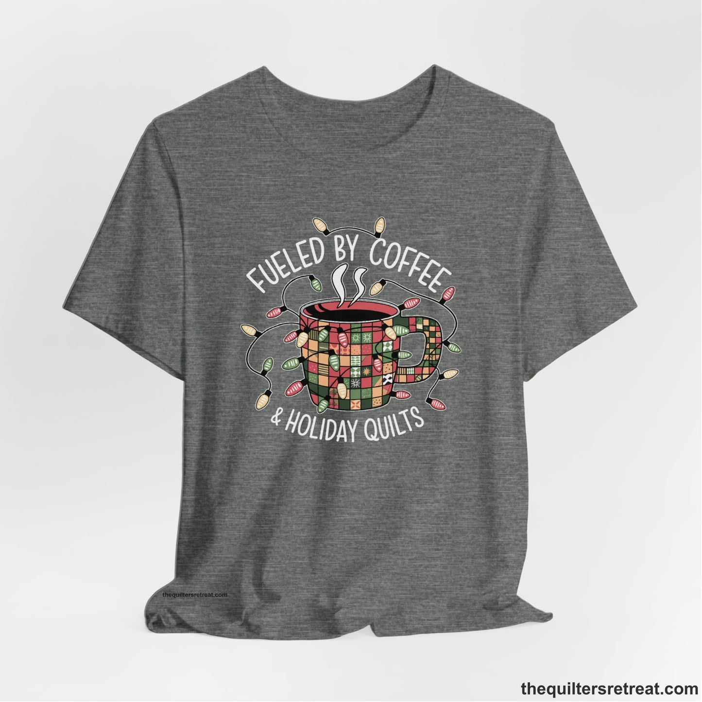 A Deep Heather Short Sleeve T-Shirt with a patchwork coffee mug with colorful lights and subtle "Fueled by Coffee" text in festive style