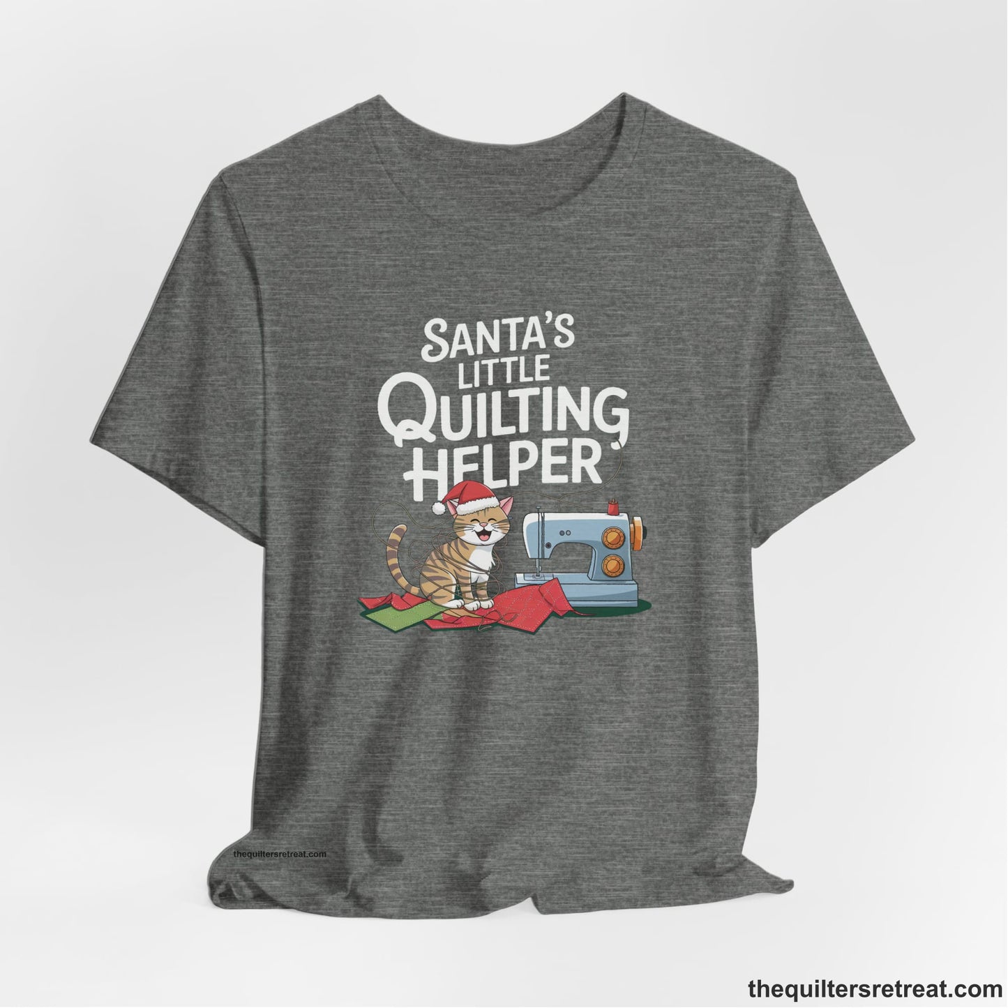 A Deep Heather Short Sleeve T-Shirt with a santa-hat-wearing kitten with a sewing machine and "Santa's Little Quilting Helper" text in playful style