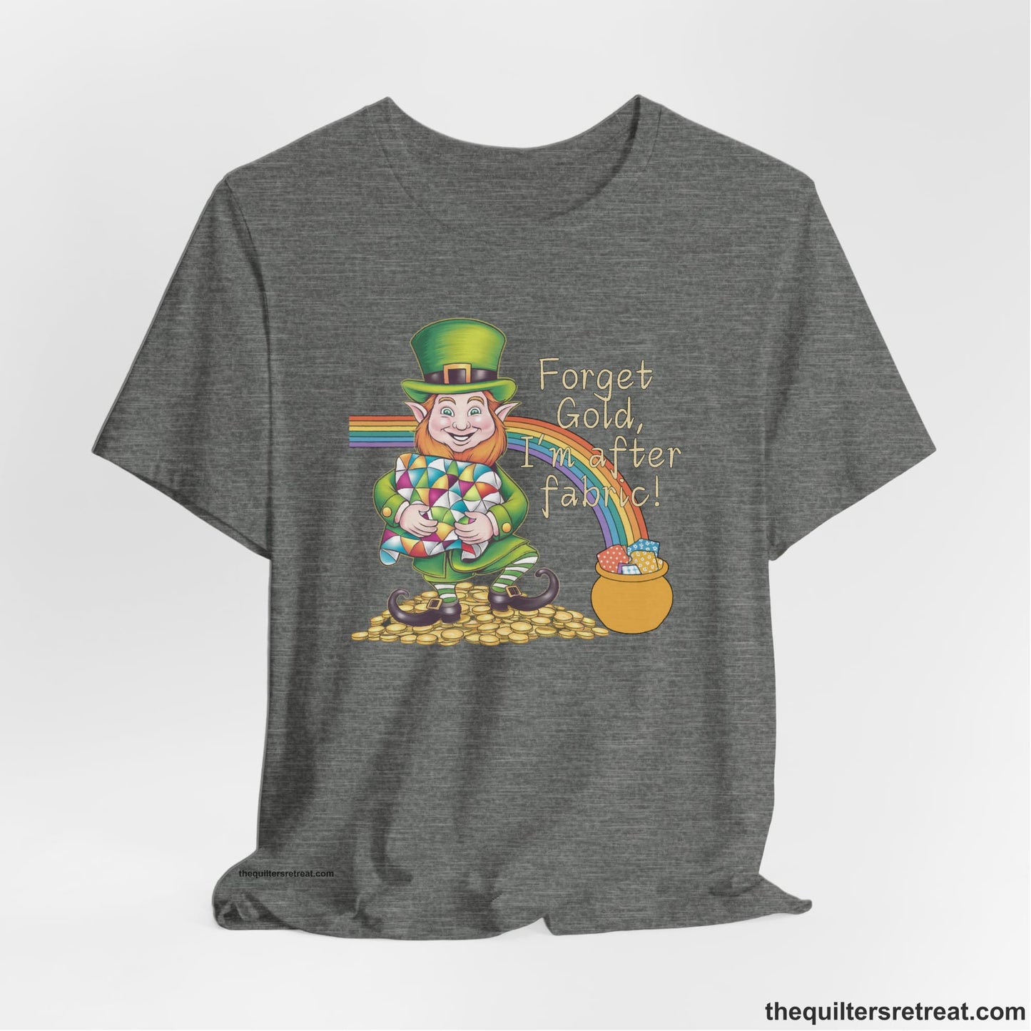 A Deep Heather Short Sleeve T-Shirt with a leprechaun with colorful quilt and rainbow, whimsical "Forget Gold, I'm after fabric!" text