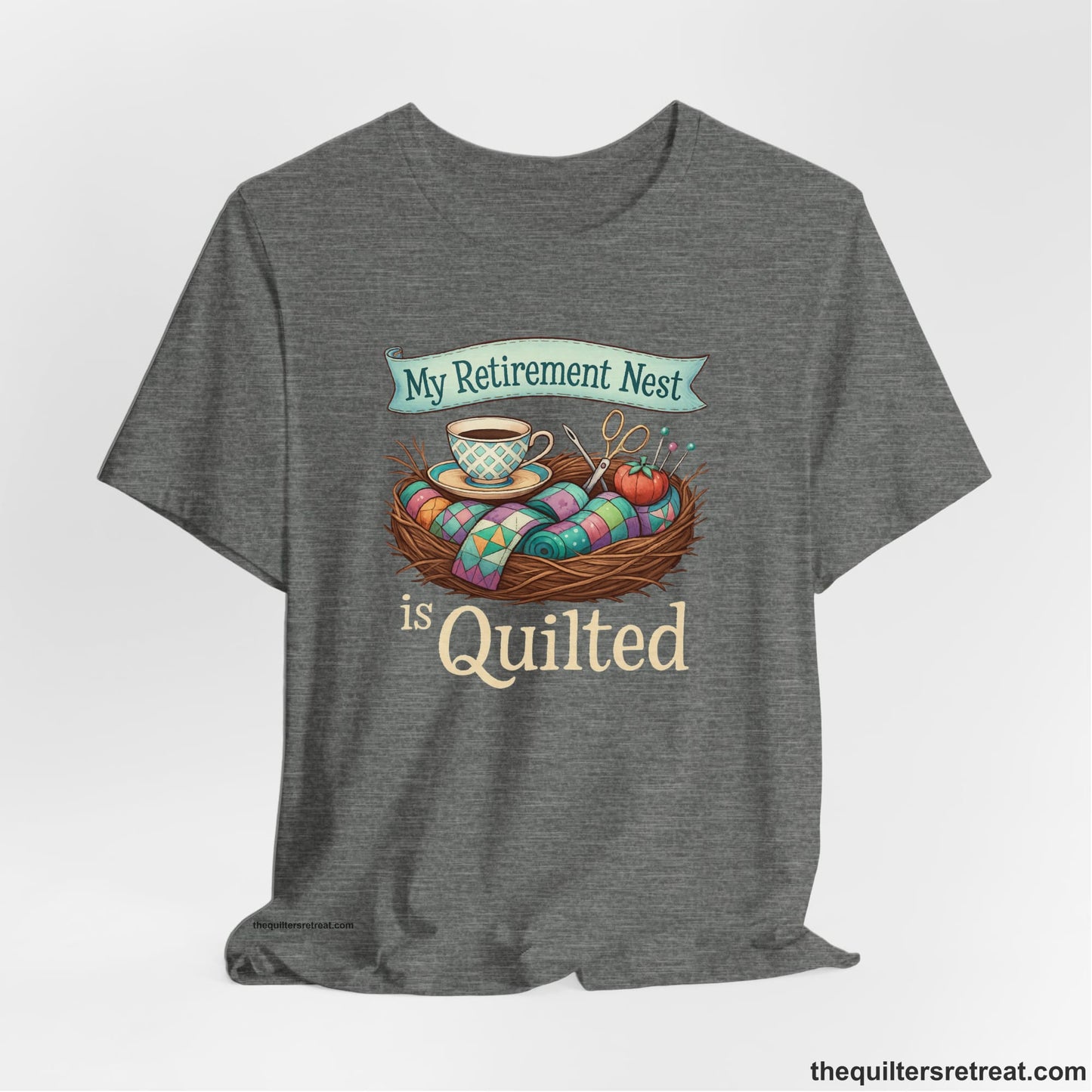 A Deep Heather Short Sleeve T-Shirt with a My Retirement Nest is Quilted text with a cozy sewing elements illustration