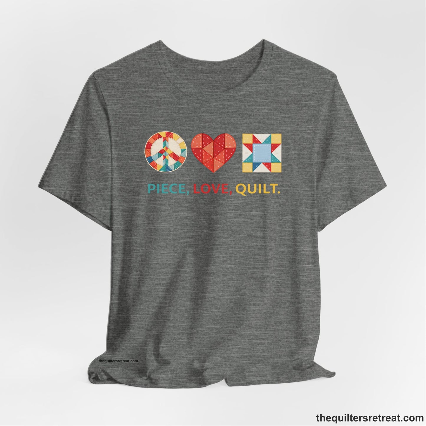 A Deep Heather Short Sleeve T-Shirt with a Colorful quilt patterns, "PIECE, LOVE, QUILT." text, whimsical style.