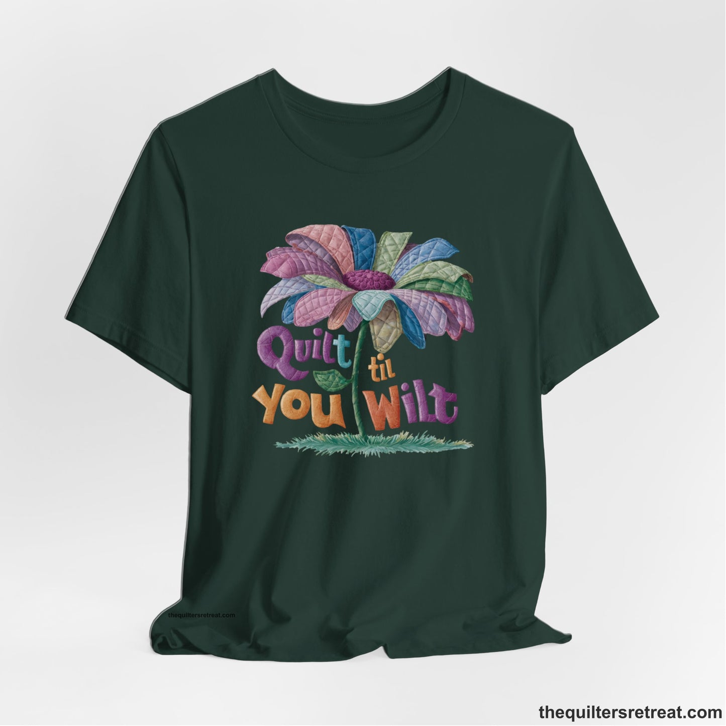 A Forest Short Sleeve T-Shirt with a whimsical quilted flower with bold "Quilt til You Wilt" text