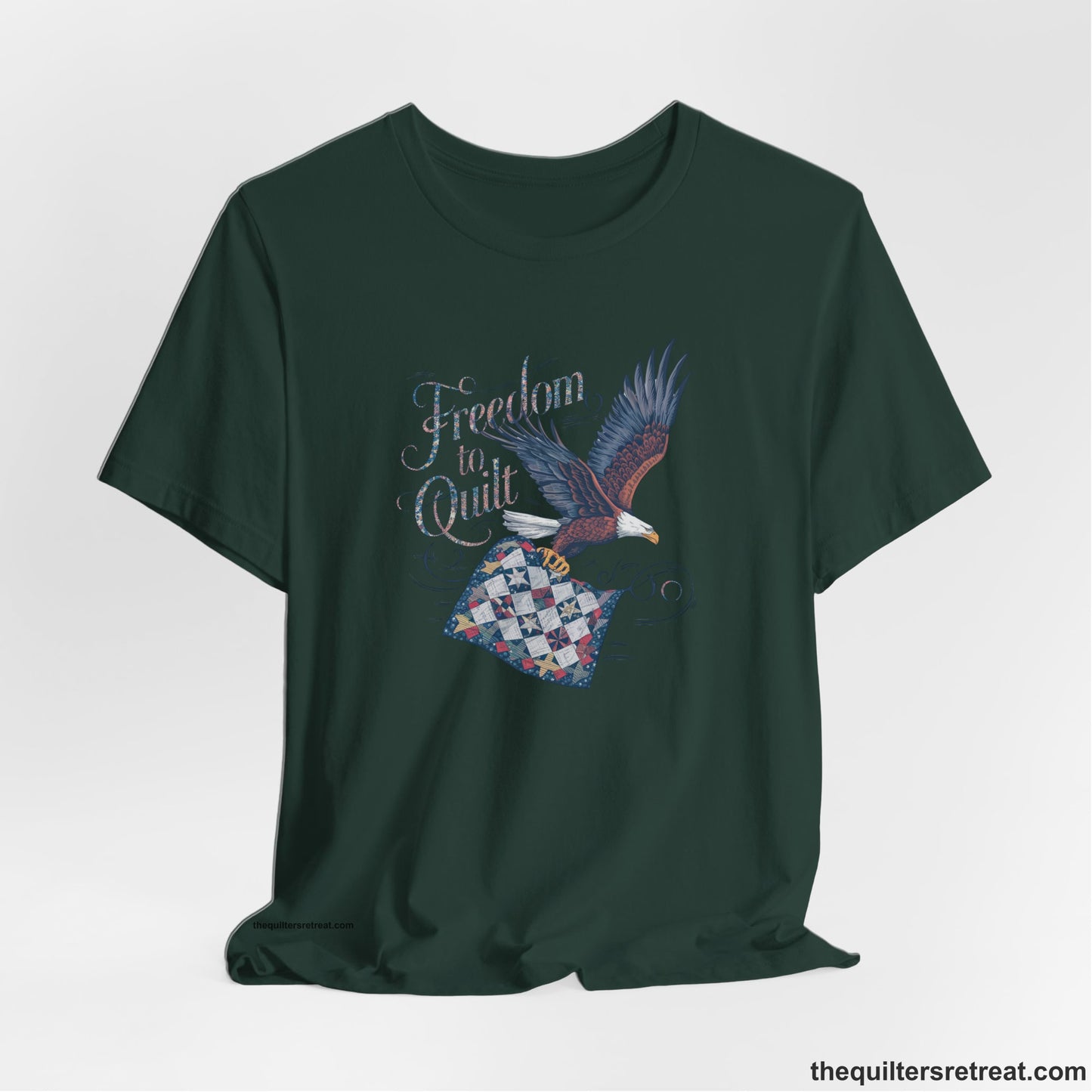 A Forest Short Sleeve T-Shirt with a freedom to quilt text with an eagle carrying a colorful patchwork quilt in vintage style