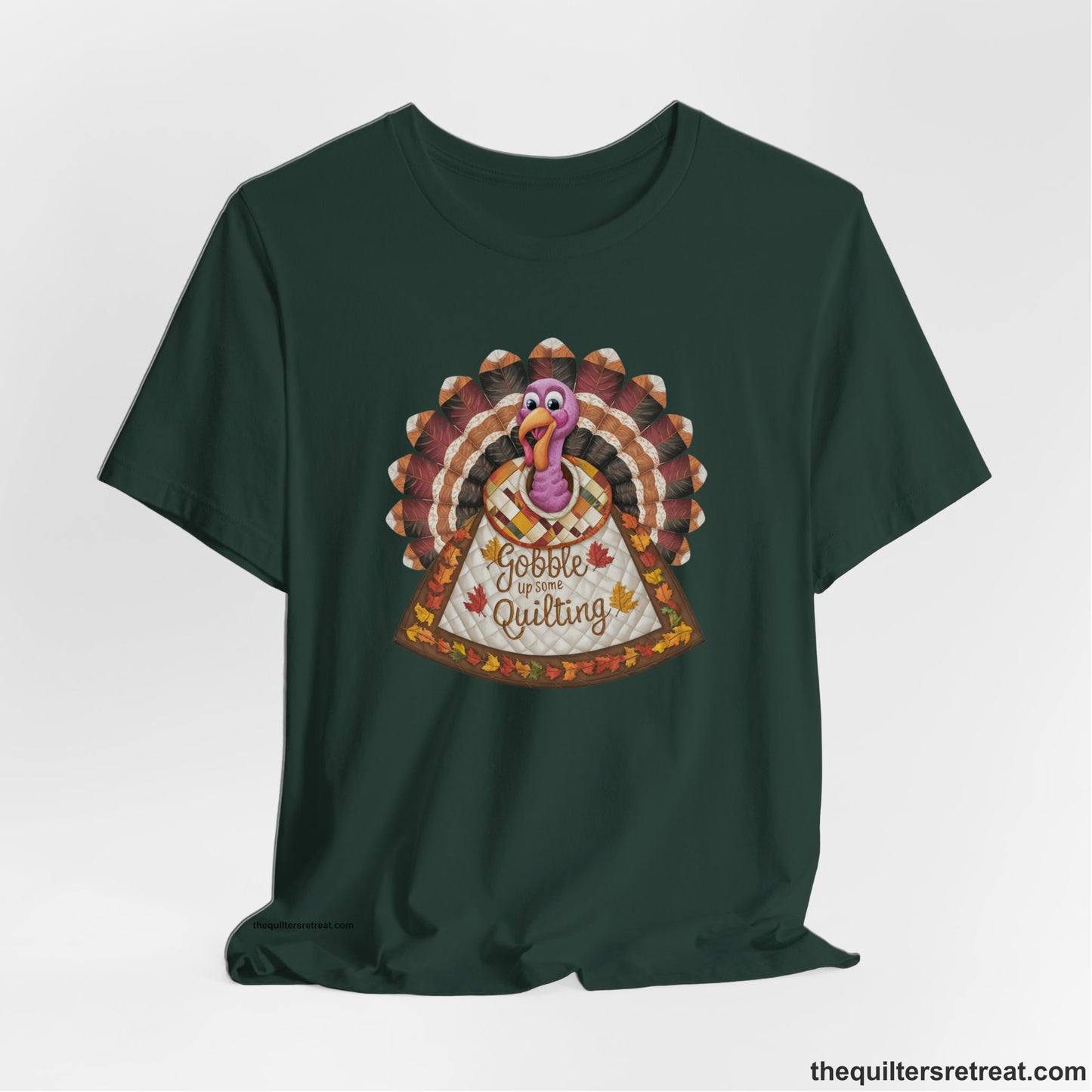A Forest Short Sleeve T-Shirt with a colorful turkey with quilted feathers and "Gobble Up Some Quilting" text in a playful style