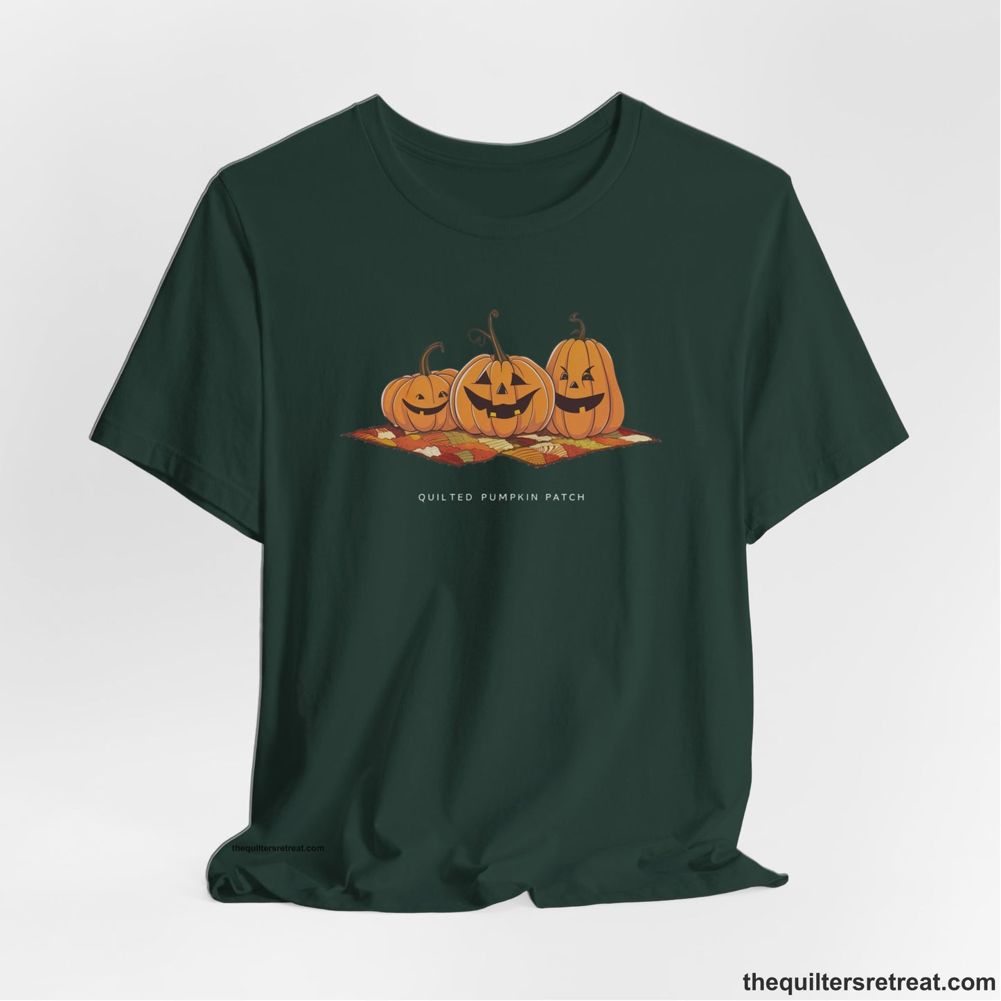 A Forest Short Sleeve T-Shirt with a playful jack-o'-lantern trio on a quilt with "Quilted Pumpkin Patch" text