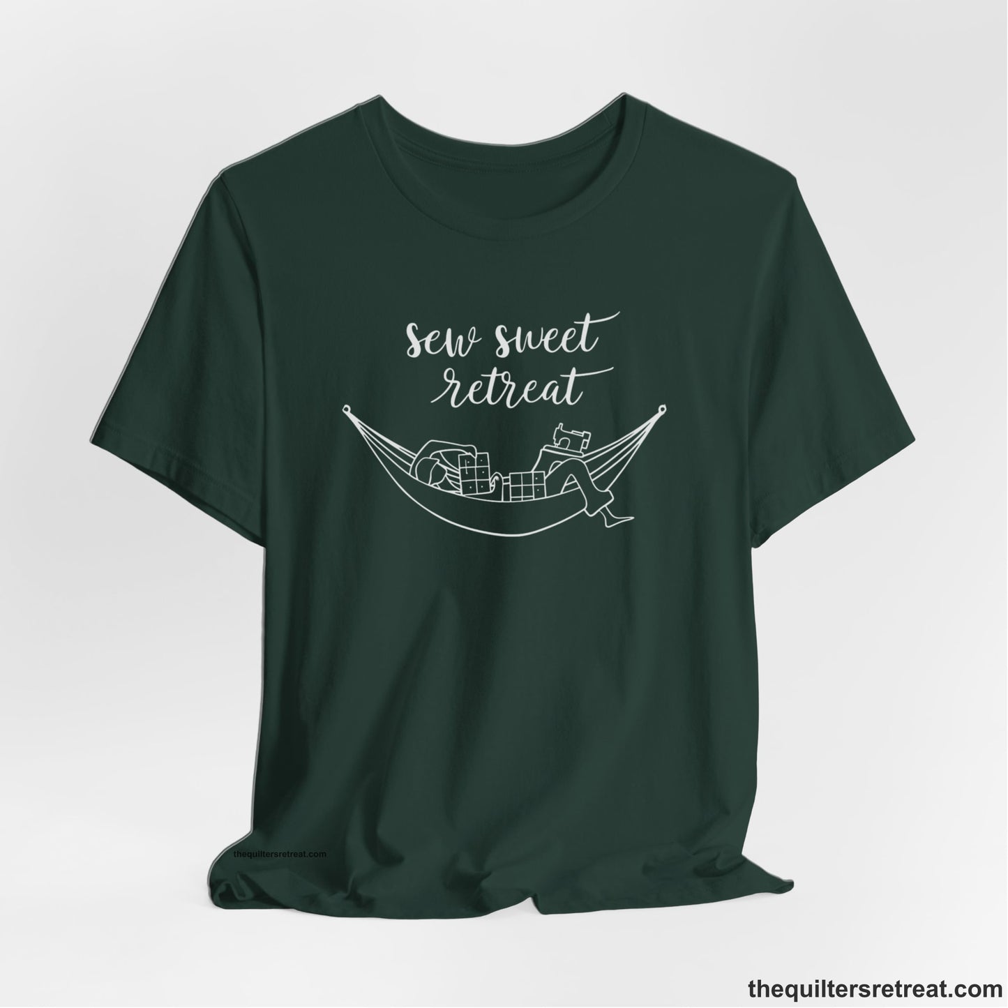 A Forest Short Sleeve T-Shirt with a sewing machine and thread spools with "Sew Sweet Retreat" in whimsical script