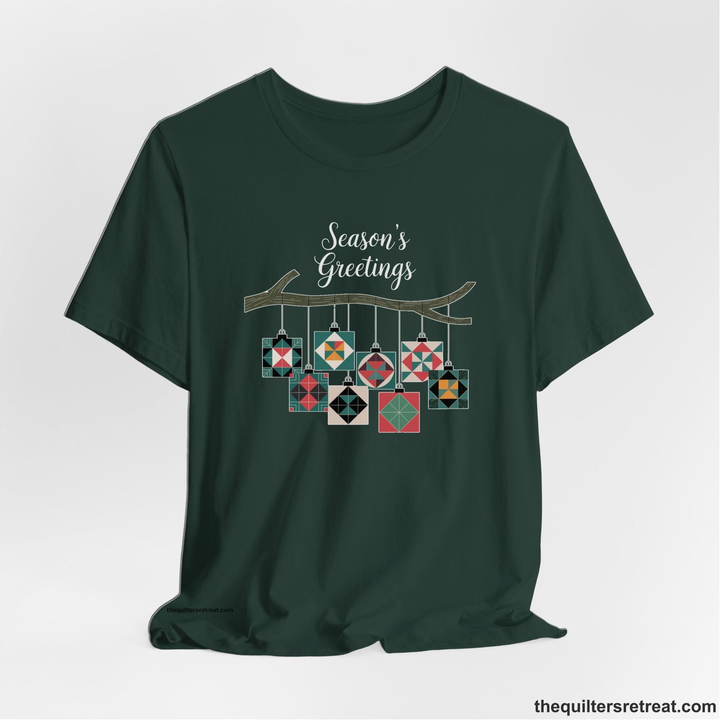 A Forest Short Sleeve T-Shirt with a season's greetings text above colorful quilt block ornaments on tree branch in rustic style
