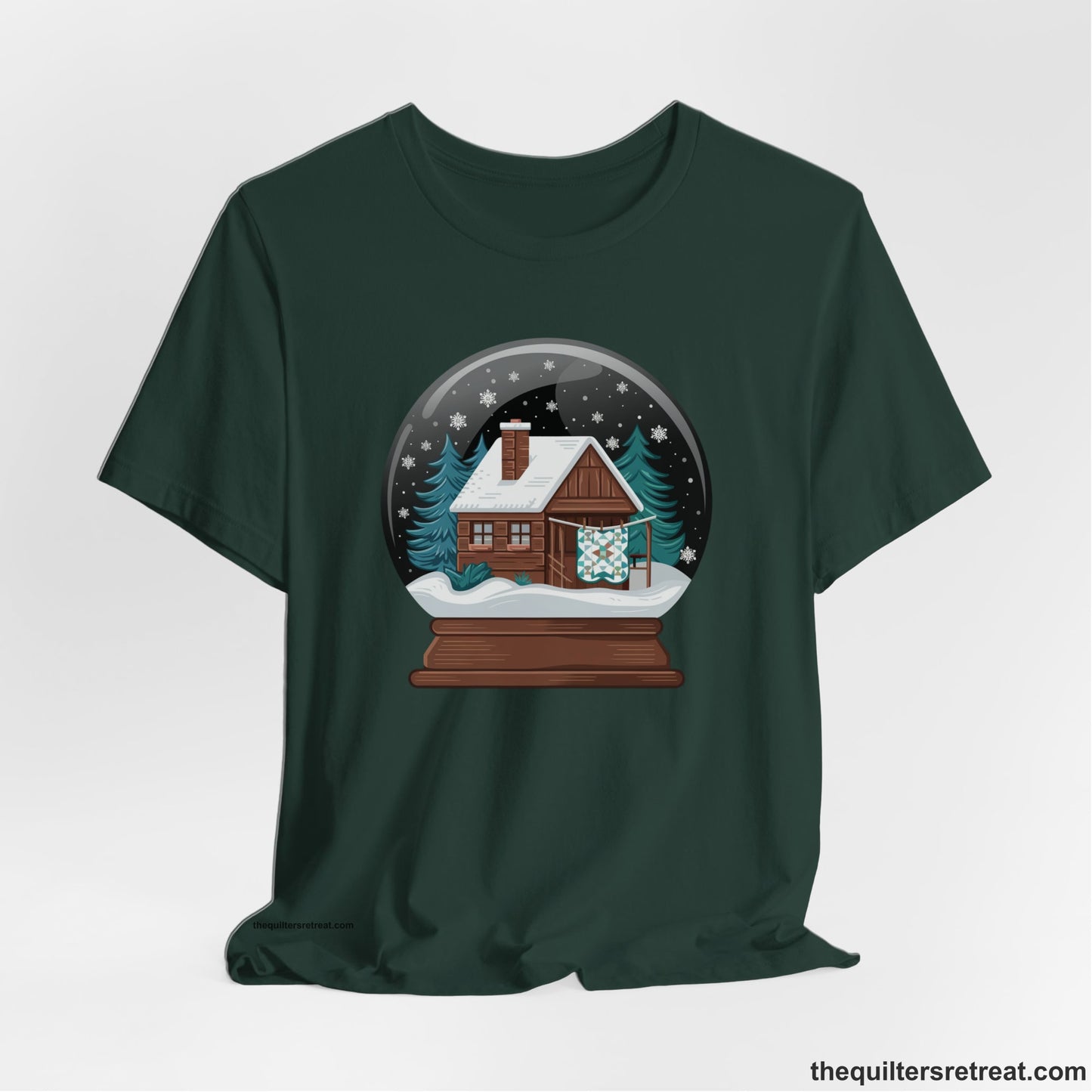 A Forest Short Sleeve T-Shirt with a cabin in a snow globe with snowflakes and trees, in a cozy rustic style