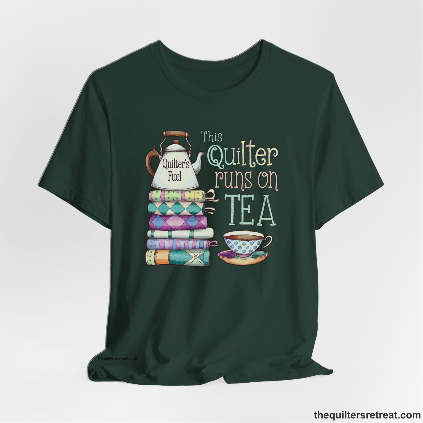 A Forest Short Sleeve T-Shirt with a stack of colorful quilts with teapot and cup, whimsical "This Quilter Runs on Tea" text