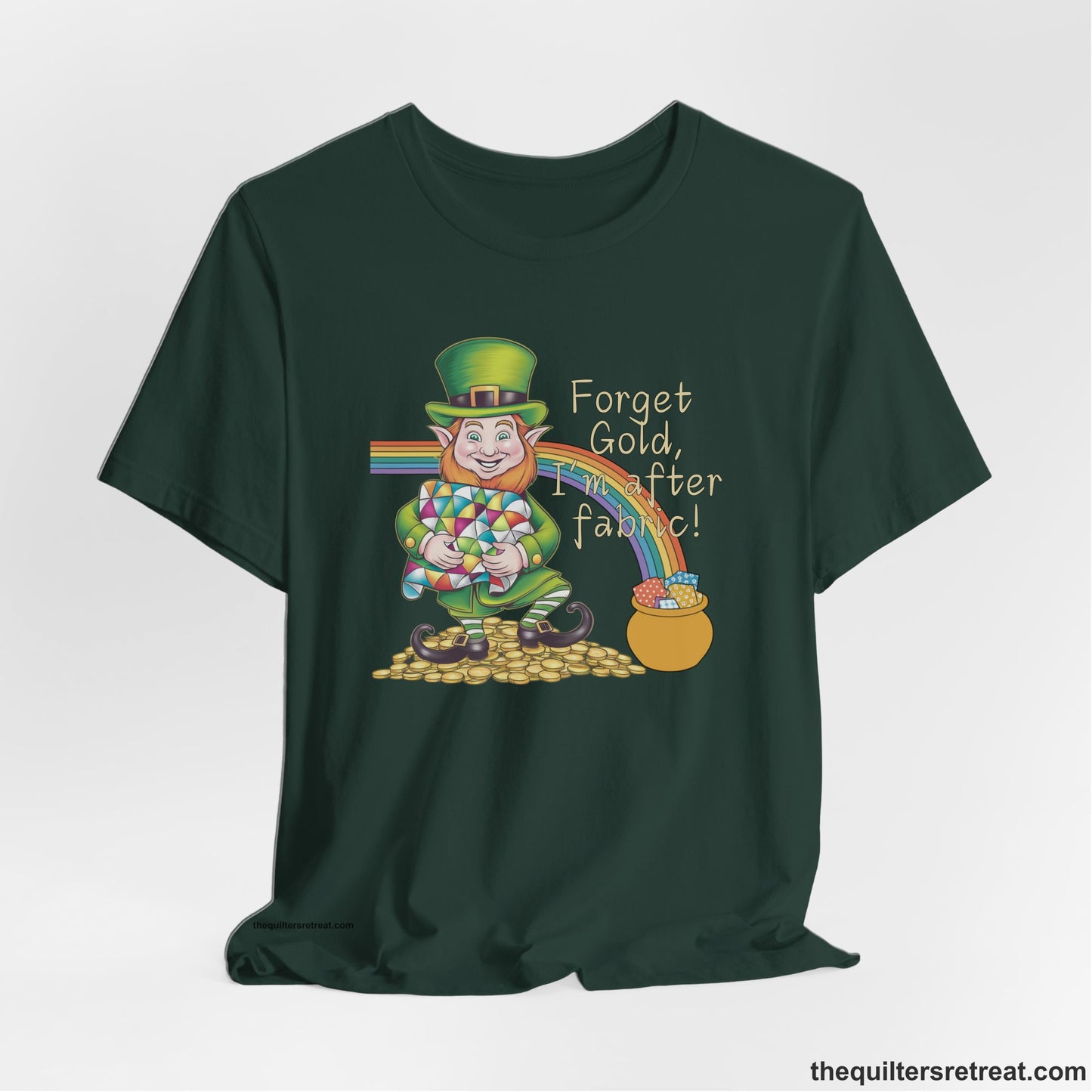 A Forest Short Sleeve T-Shirt with a leprechaun with colorful quilt and rainbow, whimsical "Forget Gold, I'm after fabric!" text