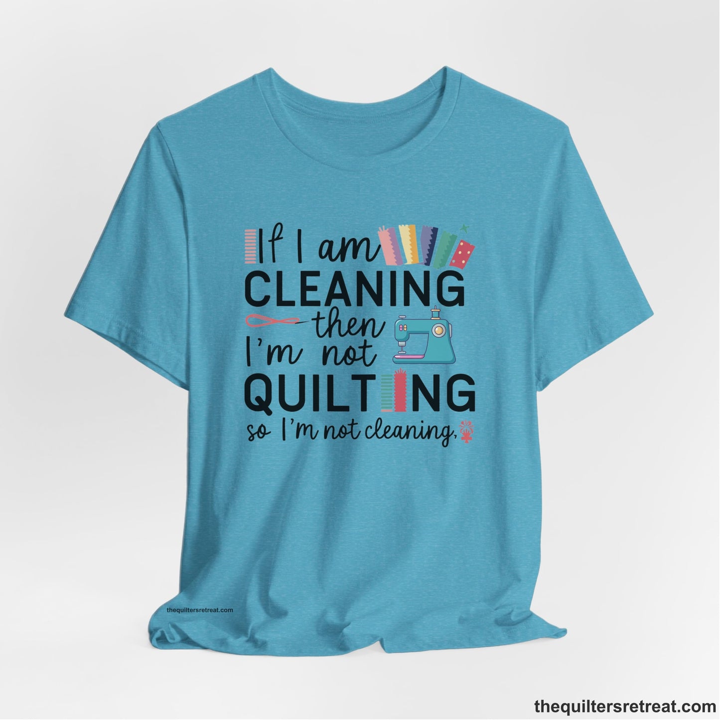 A Heather Aqua Short Sleeve T-Shirt with a If I am cleaning then I'm not quilting text with sewing machine and fabric graphics