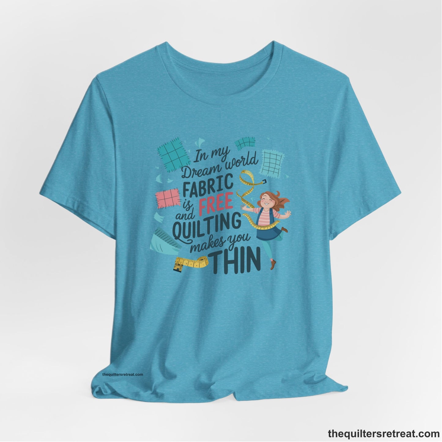 A Heather Aqua Short Sleeve T-Shirt with a inspirational quilting text with playful seamstress and colorful fabric scraps in whimsical style