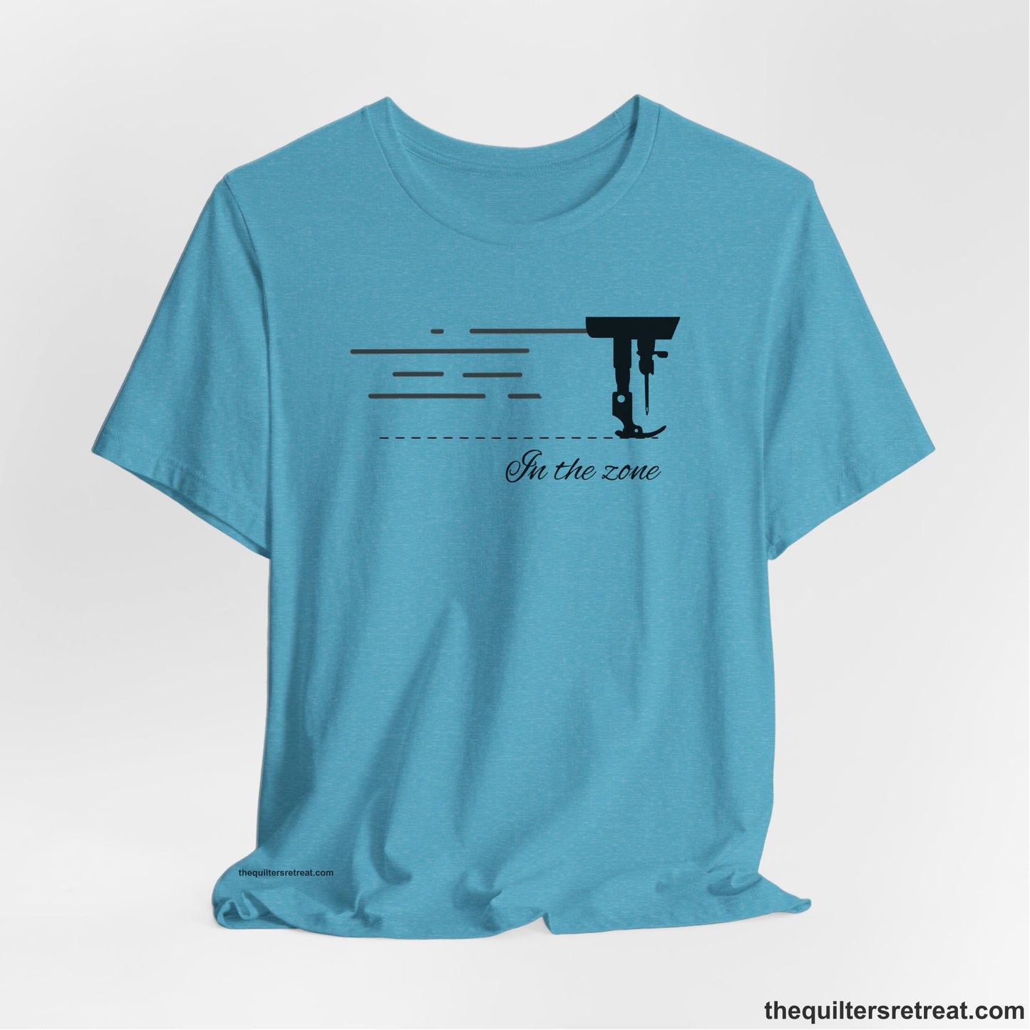 A Heather Aqua Short Sleeve T-Shirt with a vintage sewing machine illustration with floral accents and "Sewing Mends the Soul" text