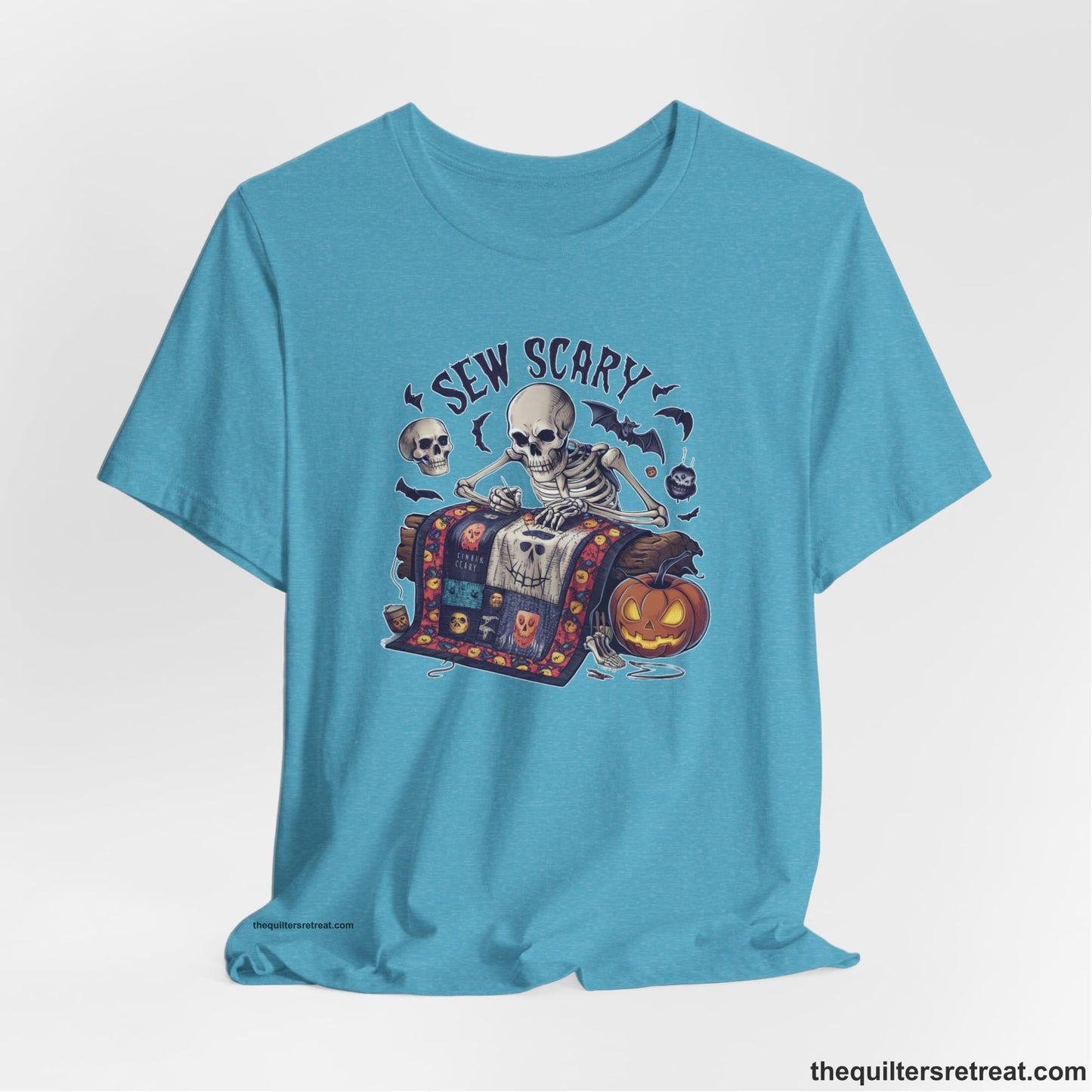 A Heather Aqua Short Sleeve T-Shirt with a skeleton quilting with spooky accents and "Sew Scary" text in a Halloween theme