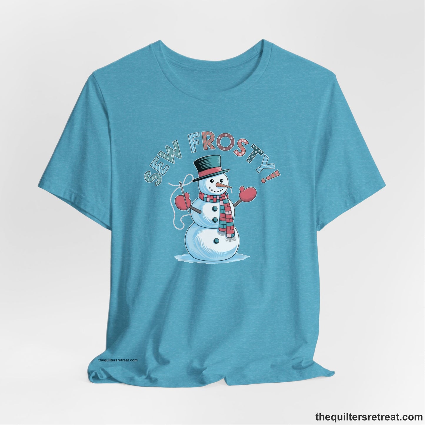 A Heather Aqua Short Sleeve T-Shirt with a playful snowman sewing illustration with "Sew Frosty!" text in a festive style