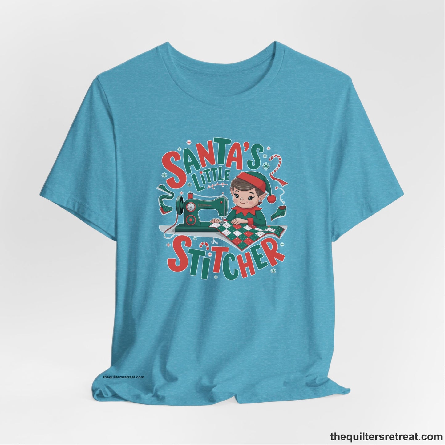 A Heather Aqua Short Sleeve T-Shirt with a santa's little stitcher elf sewing quilt with festive colors in playful style
