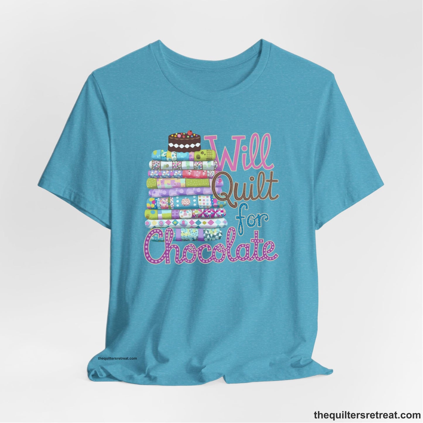 A Heather Aqua Short Sleeve T-Shirt with a stack of colorful quilts topped with cake, whimsical "Will Quilt for Chocolate" text