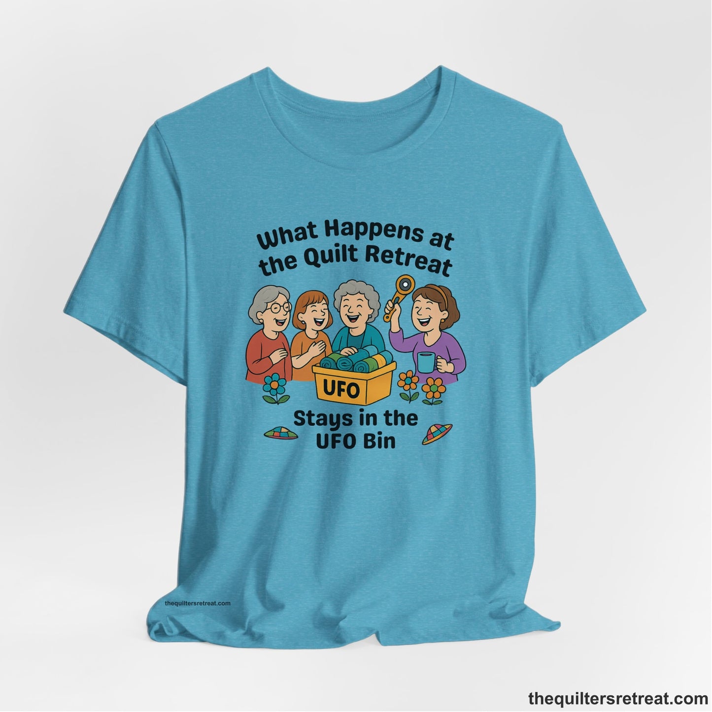 A Heather Aqua Short Sleeve T-Shirt with a four smiling women with unfinished fabric objects and playful "UFO" text in a cartoon style