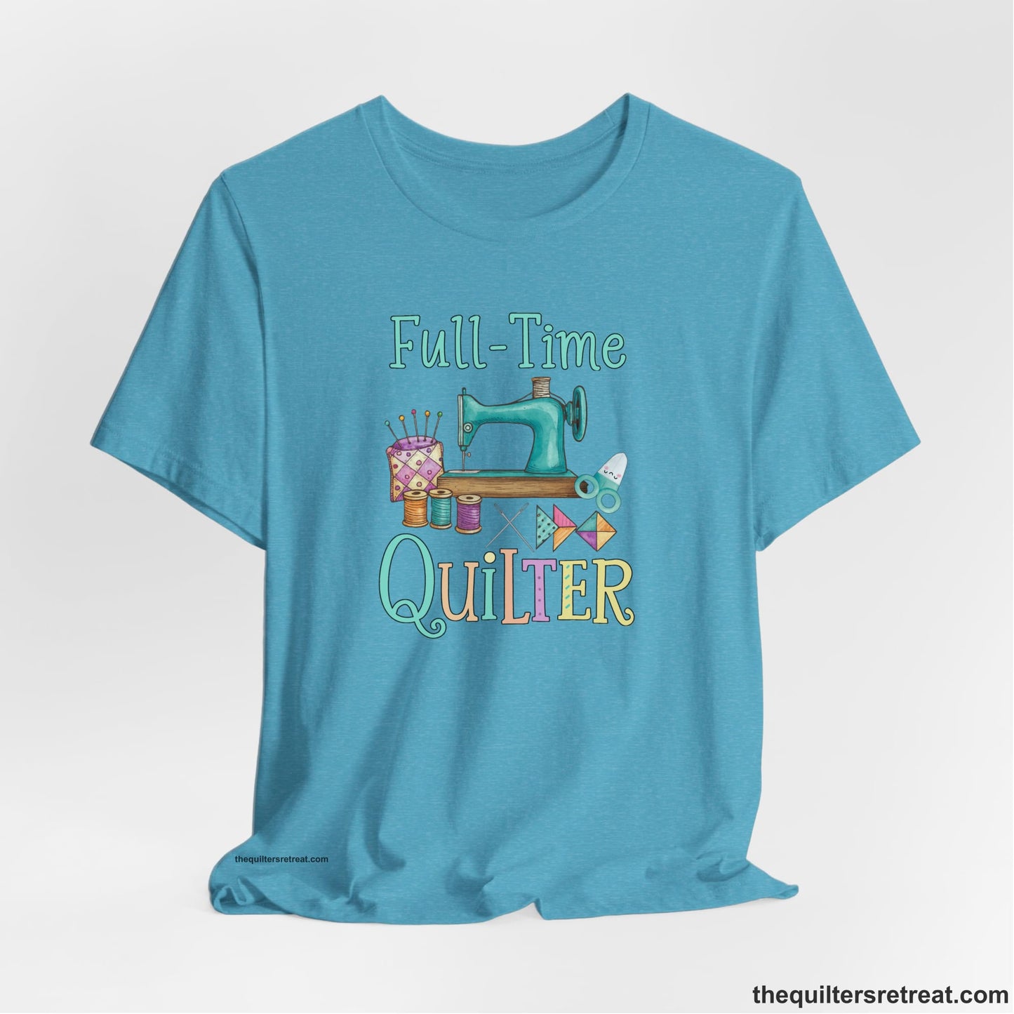 A Heather Aqua Short Sleeve T-Shirt with a vintage sewing machine with colorful threads and "Full-Time Quilter" text in playful style