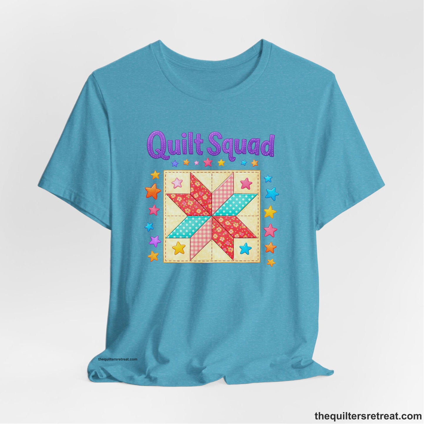 A Heather Aqua Short Sleeve T-Shirt with a Patchwork quilt star with colorful stars, playful mood, "Quilt Squad" text.