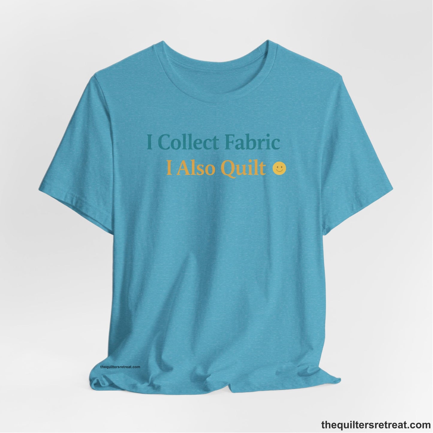 A Heather Aqua Short Sleeve T-Shirt with a Colorful text saying "I Collect Fabric I Also Quilt" with a playful, cheerful vibe.