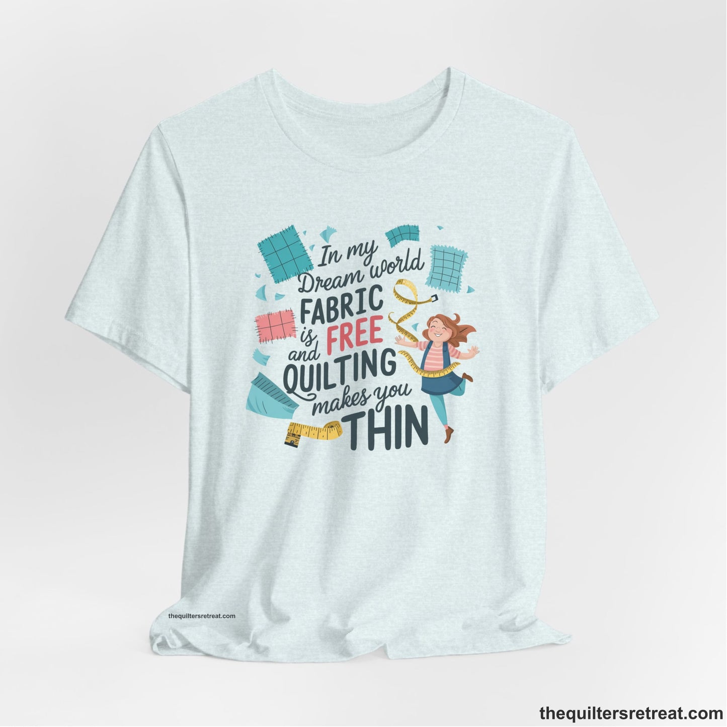 A Heather Ice Blue Short Sleeve T-Shirt with a inspirational quilting text with playful seamstress and colorful fabric scraps in whimsical style