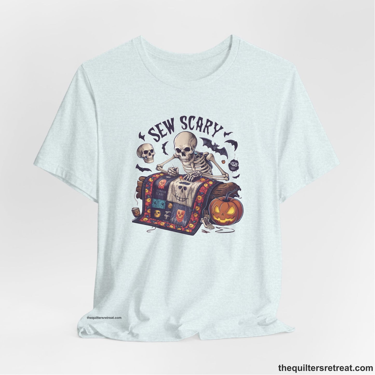 A Heather Ice Blue Short Sleeve T-Shirt with a skeleton quilting with spooky accents and "Sew Scary" text in a Halloween theme