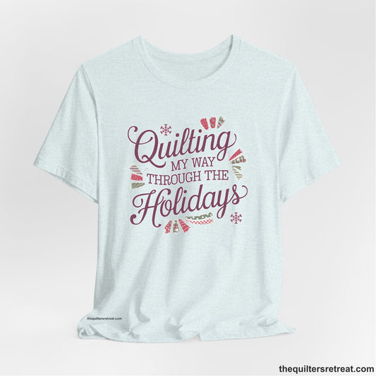 A Heather Ice Blue Short Sleeve T-Shirt with a quilting-themed text in festive colors with decorative quilt patterns