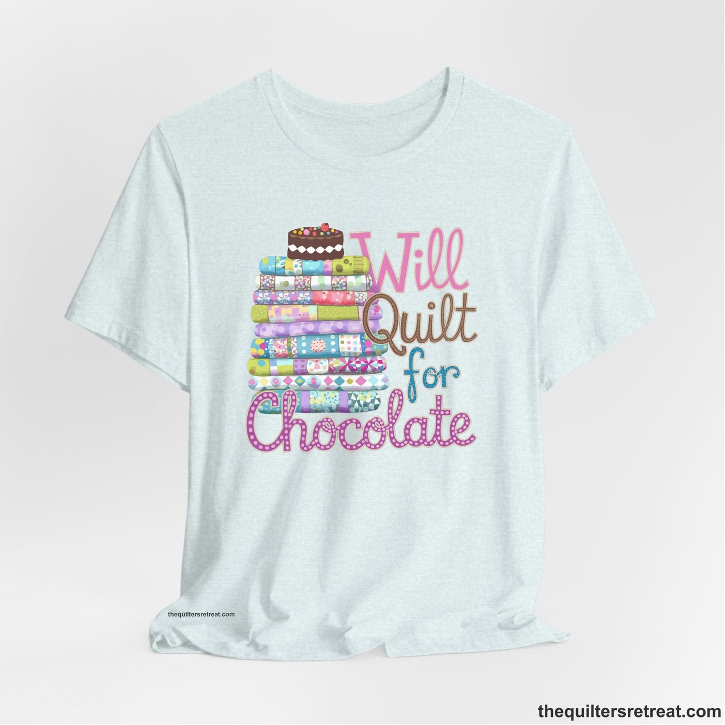 A Heather Ice Blue Short Sleeve T-Shirt with a stack of colorful quilts topped with cake, whimsical "Will Quilt for Chocolate" text