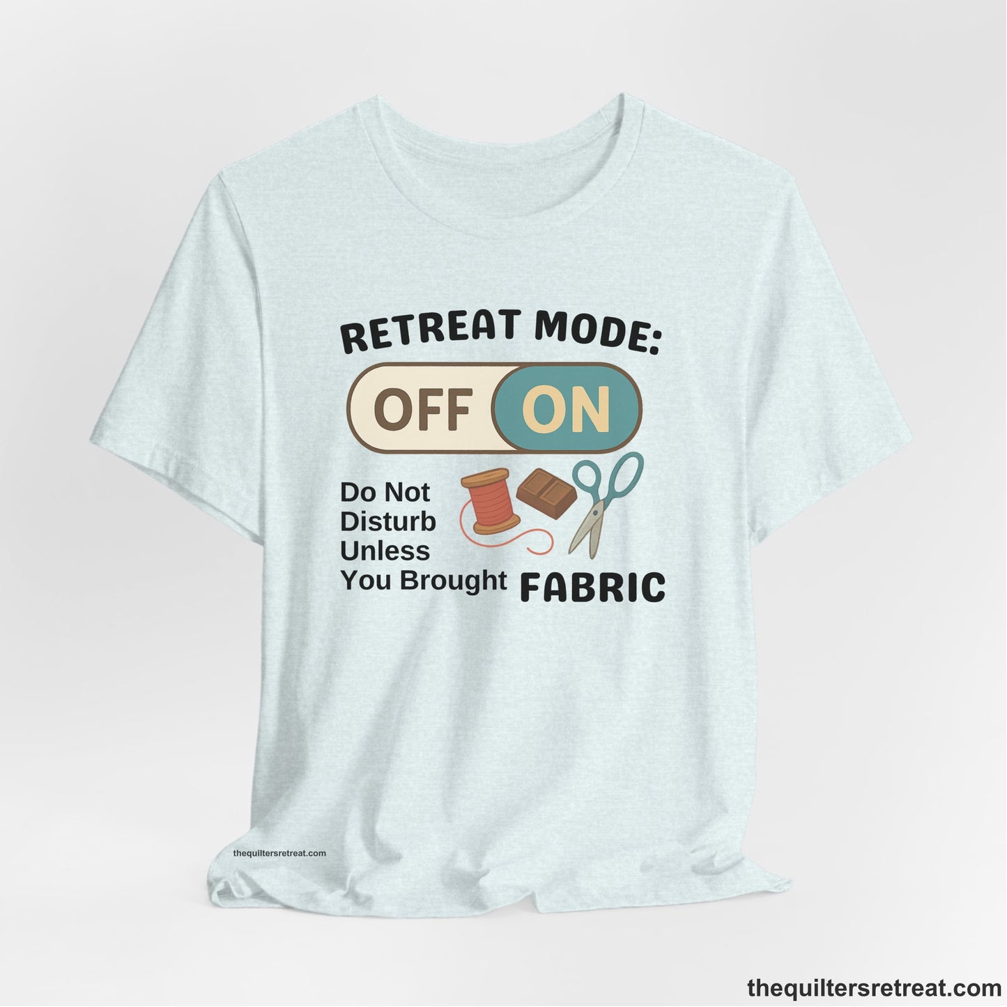 A Heather Ice Blue Short Sleeve T-Shirt with a illustration of sewing tools with a playful "OFF ON" switch design
