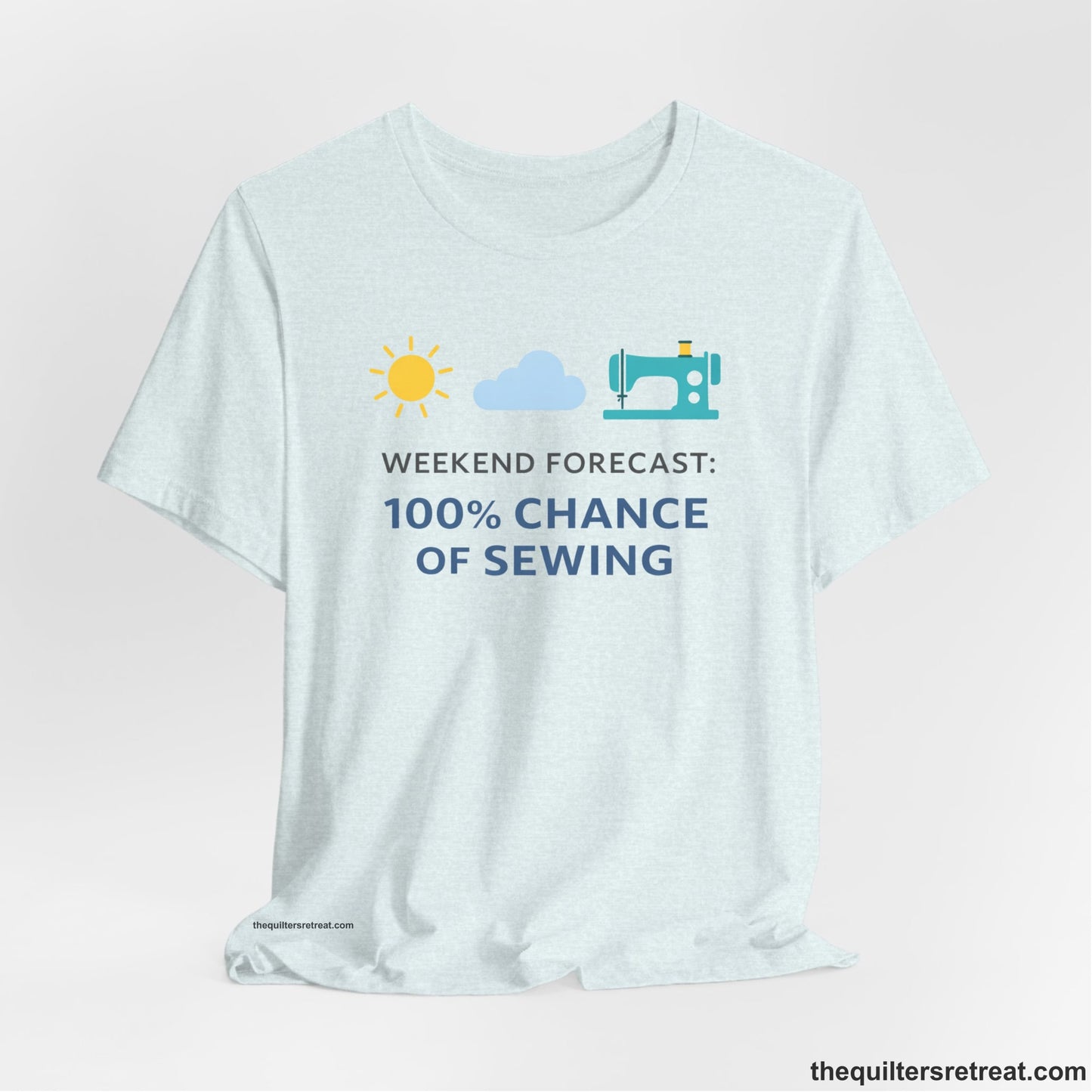 A Heather Ice Blue Short Sleeve T-Shirt with a Sun, cloud, sewing machine icons; bold text "Weekend Forecast: 100% Chance of Sewing"; playful style.