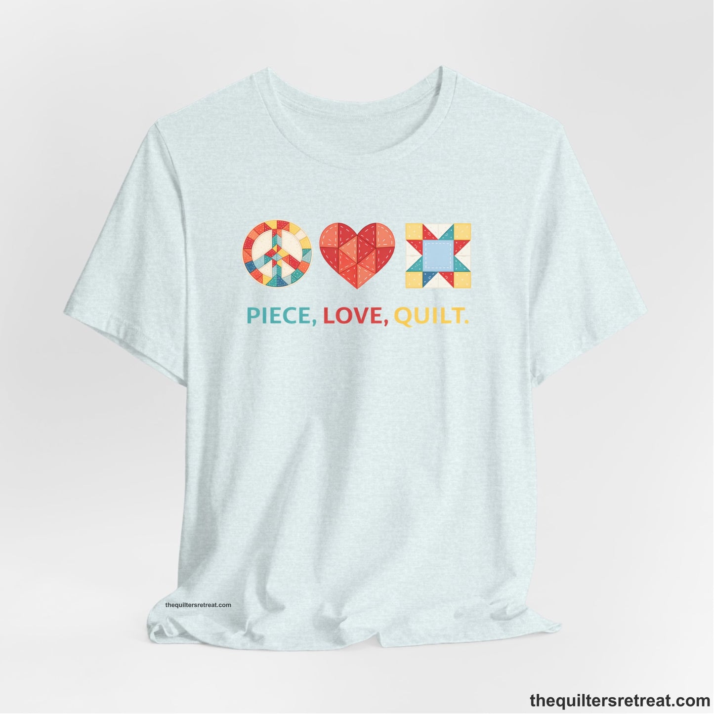 A Heather Ice Blue Short Sleeve T-Shirt with a Colorful quilt patterns, "PIECE, LOVE, QUILT." text, whimsical style.