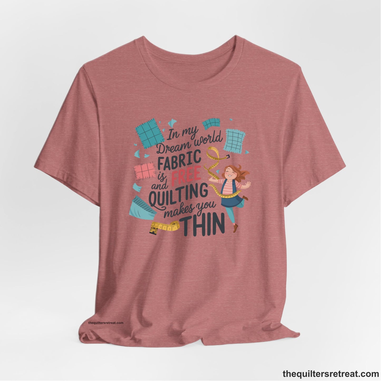 A Heather Mauve Short Sleeve T-Shirt with a inspirational quilting text with playful seamstress and colorful fabric scraps in whimsical style