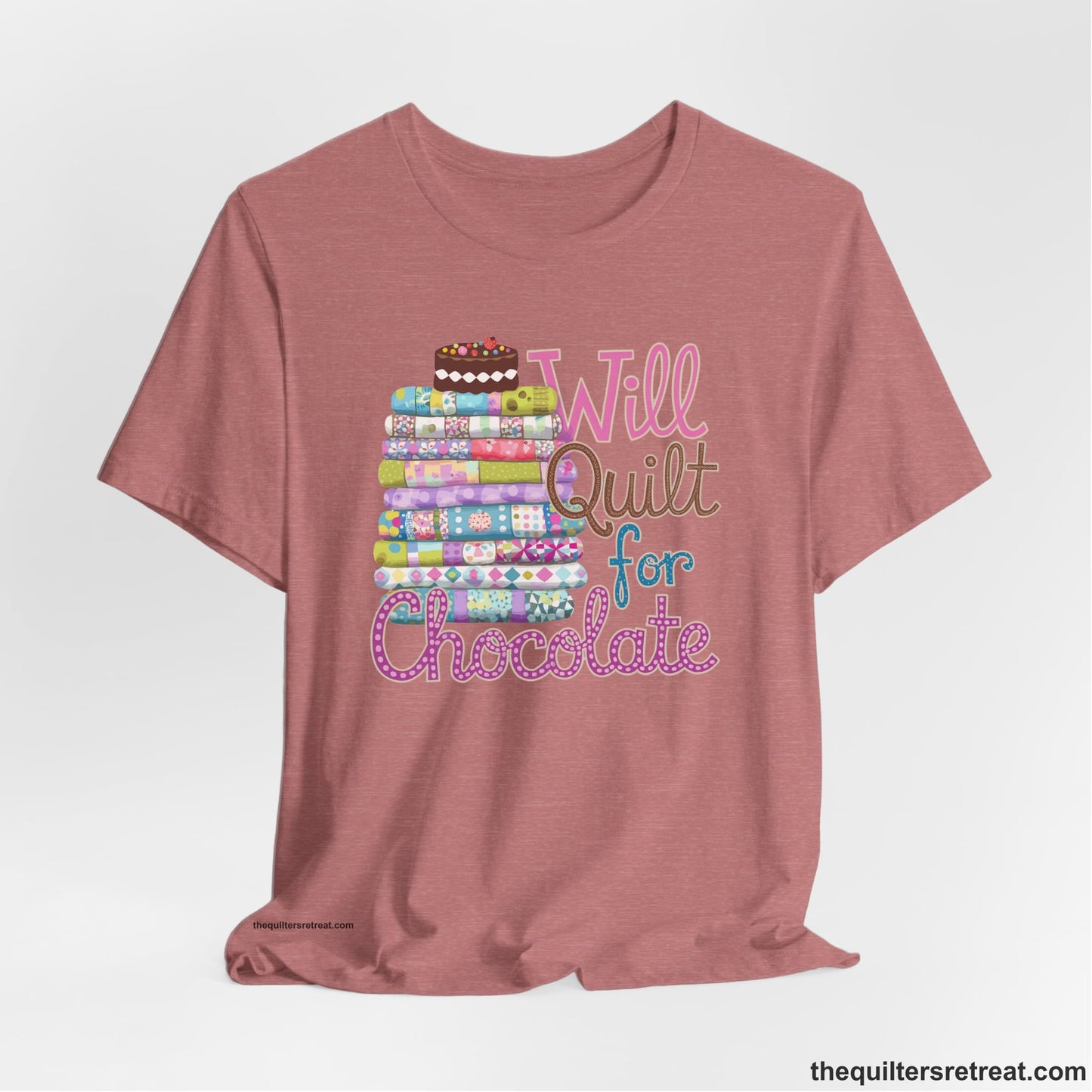 A Heather Mauve Short Sleeve T-Shirt with a stack of colorful quilts topped with cake, whimsical "Will Quilt for Chocolate" text