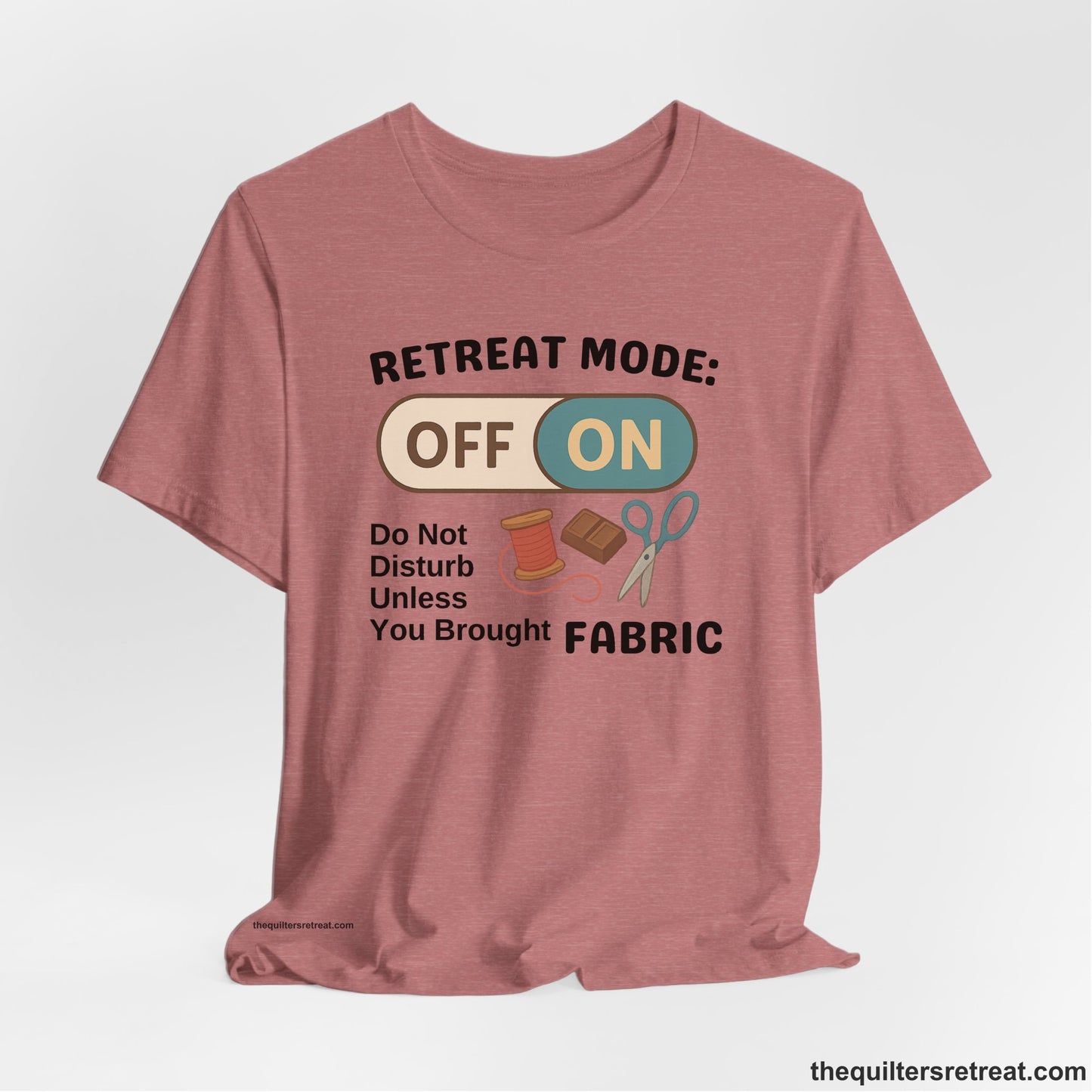 A Heather Mauve Short Sleeve T-Shirt with a illustration of sewing tools with a playful "OFF ON" switch design