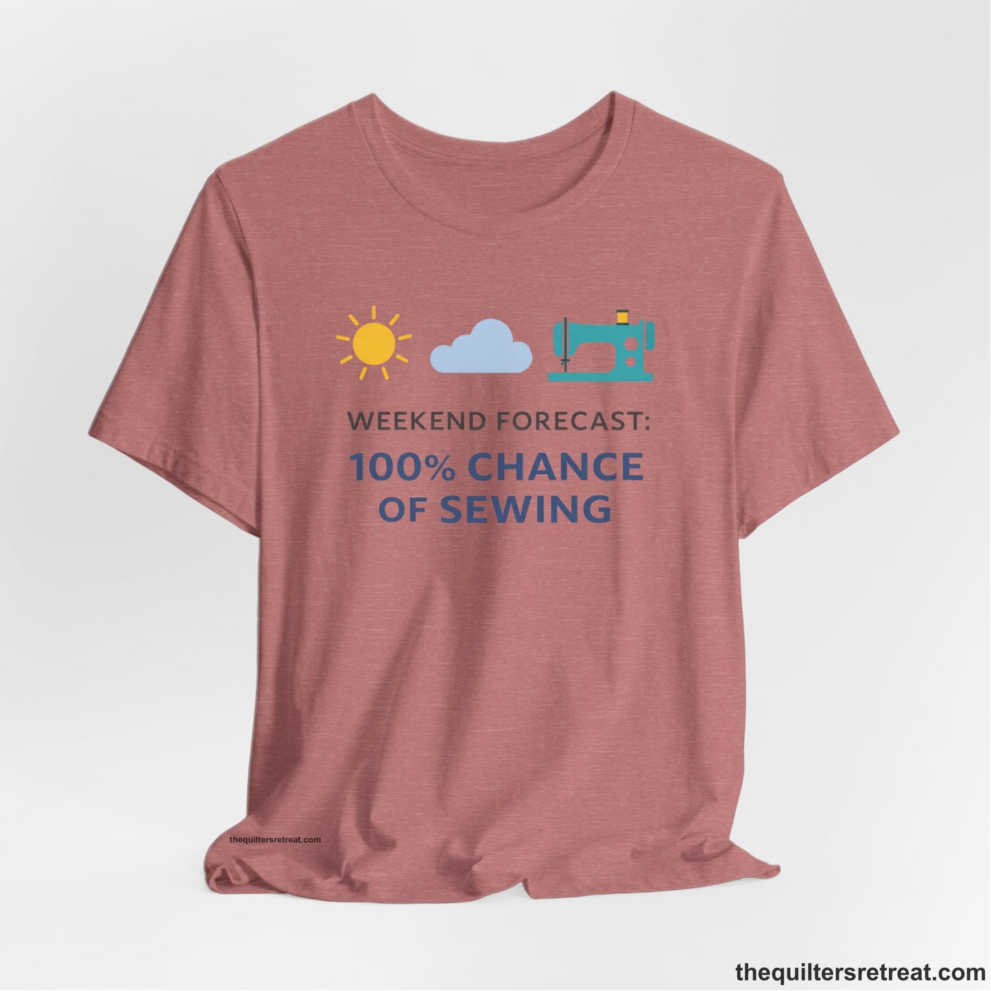 A Heather Mauve Short Sleeve T-Shirt with a Sun, cloud, sewing machine icons; bold text "Weekend Forecast: 100% Chance of Sewing"; playful style.