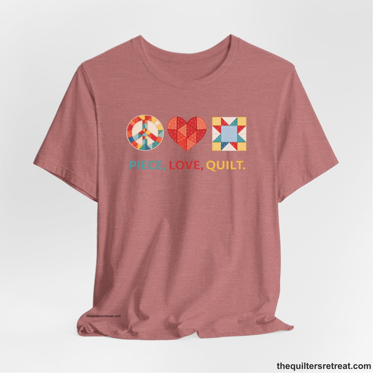 A Heather Mauve Short Sleeve T-Shirt with a Colorful quilt patterns, "PIECE, LOVE, QUILT." text, whimsical style.