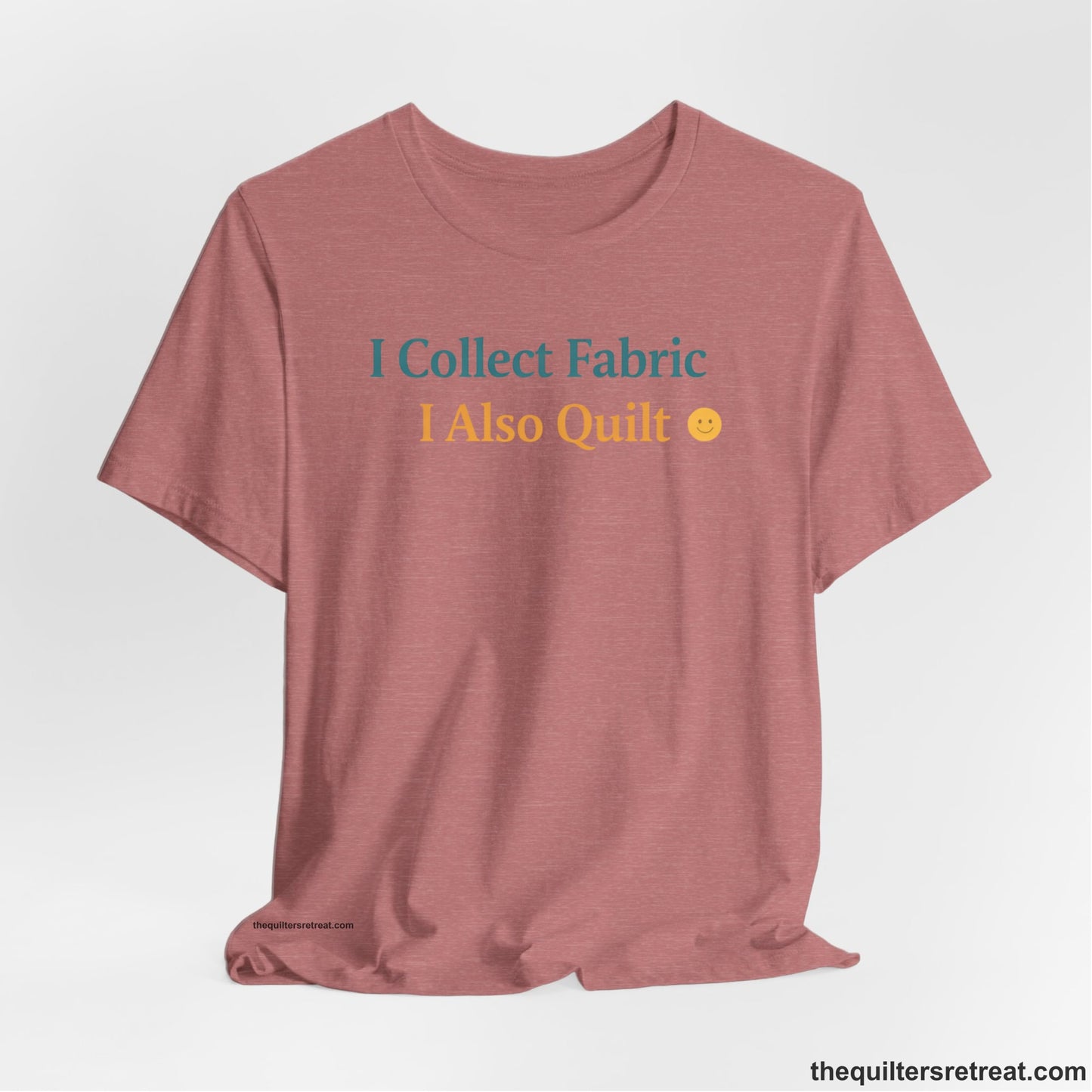 A Heather Mauve Short Sleeve T-Shirt with a Colorful text saying "I Collect Fabric I Also Quilt" with a playful, cheerful vibe.