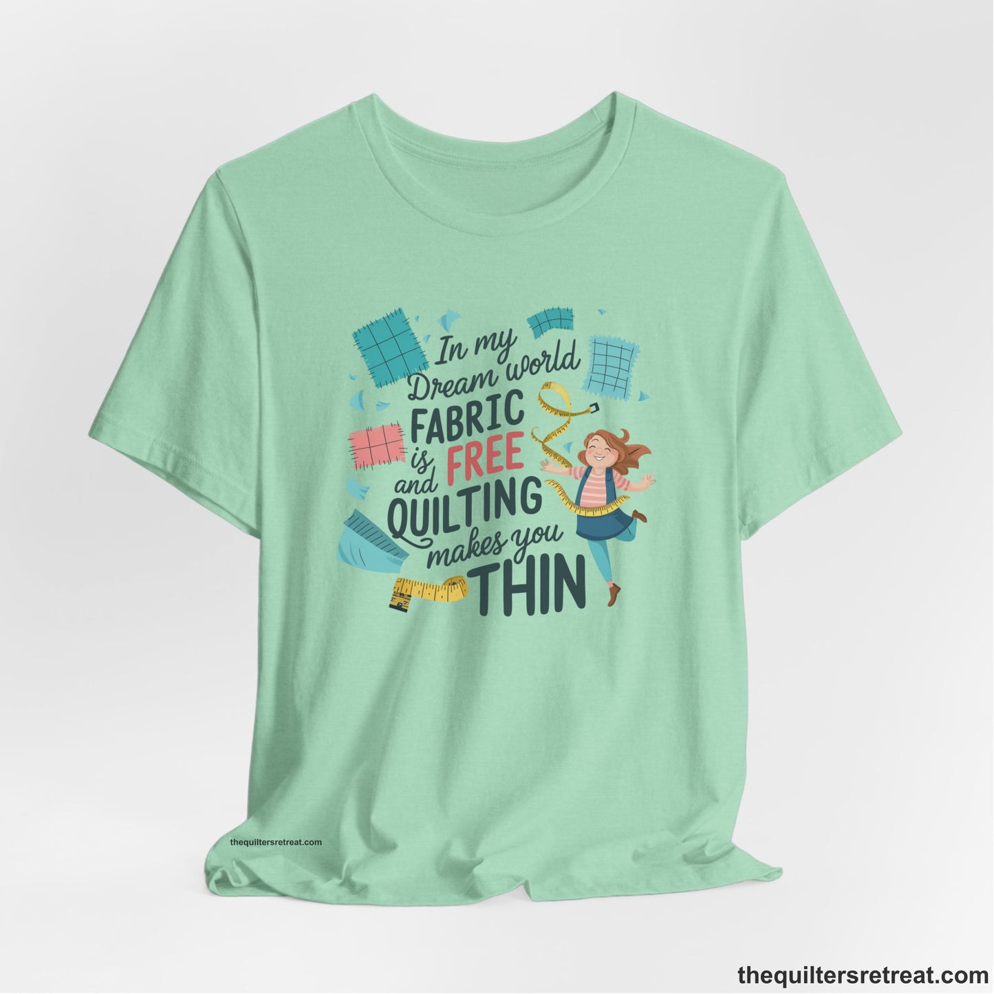 A Heather Mint Short Sleeve T-Shirt with a inspirational quilting text with playful seamstress and colorful fabric scraps in whimsical style