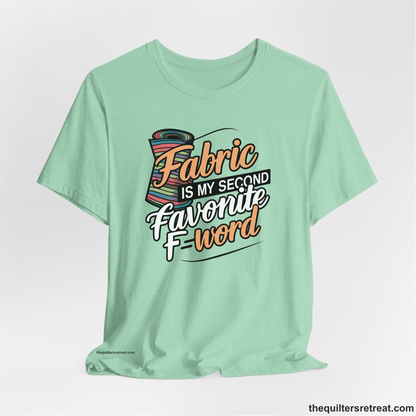 A Heather Mint Short Sleeve T-Shirt with a fabric bolt illustration with bold "Fabric Is My Second Favorite F Word" text